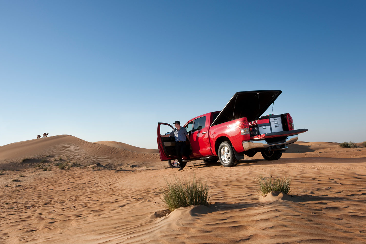 Camioneta  pick-up roja con sistema de estanterías modul-system en un desierto